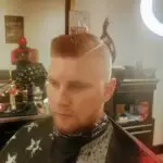 client with a sharp haircut. Long on the top and styled.