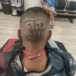Client with a fade haircut with a custom design of the large letters J and P